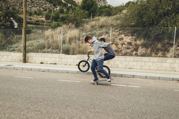 Young people with skateboard and bmx bike. Extreme urban sports concept