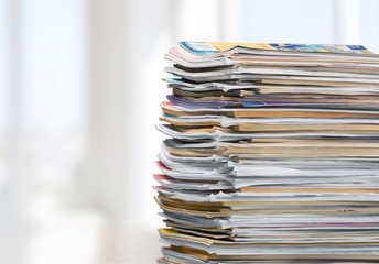 Pile of newspapers on white background