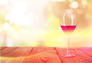 Red wine glass on wooden desk