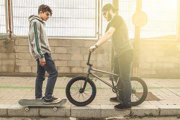 Young people with skateboard and bmx bike. Extreme urban sports concept
