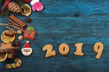 Gingerbreads cookies for new 2019 year on wooden background, xmas theme