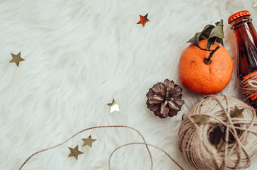 winter composition with twine, tangerine and cones
