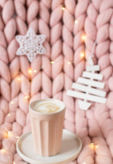 Pink pastel merino woolen giant blanket, gingerbread deer, cup with cappuccino, Christmas toy, New Year Concept, Lights 