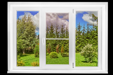 Garden view from a country house window in a sunny summer day isolated on the black
