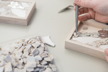 Hands Artist working on stones mosaic