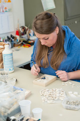 Female Artist working on stones mosaic