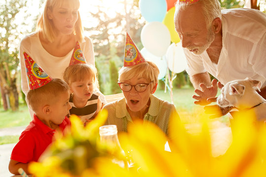 Happy Extended Family On A Garden Birthday Party