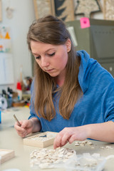 Female Artist working on stones mosaic