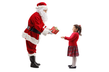Santa Claus giving a present to a happy little girl