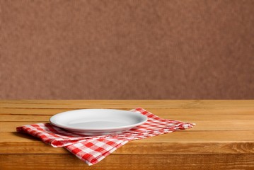 White circle Plate on napkin on wooden table