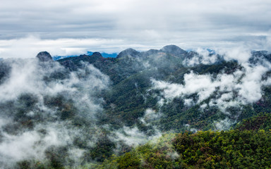 Aerial view of foggy green mountain