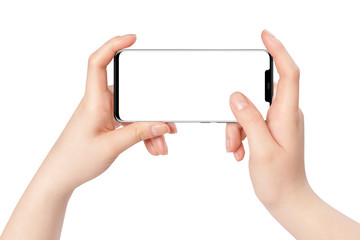 Female hands holding new modern black phone in horizontal position with empty screen on white...