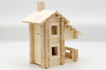 Obraz na płótnie Canvas Toy wooden house on a white background (building model)
