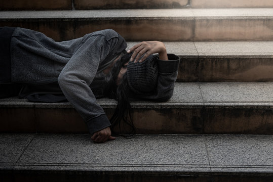 Beggars, Homeless people Lie on the steps, ask for a fraction of money from people travelng to buy food to live, to homeless concept.