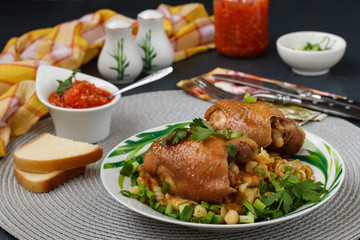Chicken thighs with spices, soy sauce, green onion and side dish