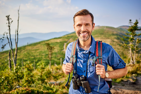 Portrait of smiling man hiking in the mountains