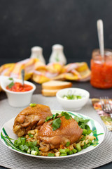 Chicken thighs with spices, soy sauce, green onion and side dish