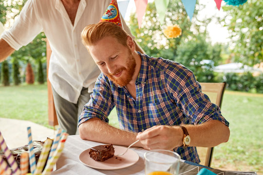 Man Eating Cake On A Birthday Garden Party