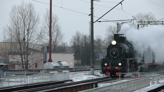 steam train in a cloud of smoke is approaching, tracking shot