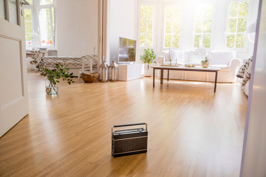 Transistor radio standing on parquet in a modern living room