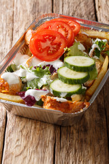 Kapsalon is a Dutch food item consisting of fries, topped with döner or shawarma meat and grilled...