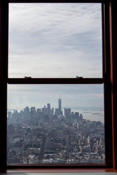 View of Lower Manhattan from The Empire State Building observation deck window.