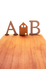 housing and life symbol on wooden board