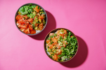 Poke bowl with marinated salmon and vegetable salad on rice