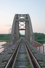 stone railway bridge over the river going into the distance