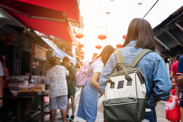 Asian women traveler in china market. she is shopping and travel.