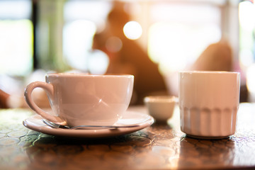 Hot art Latte Coffee in a cup on wooden table in Coffee shop blur background. business time and coffee break.