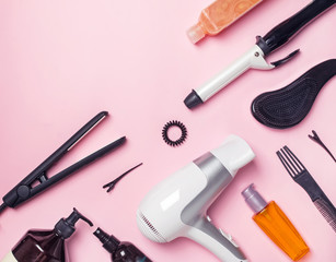 Hair styling and care items and products on pink background