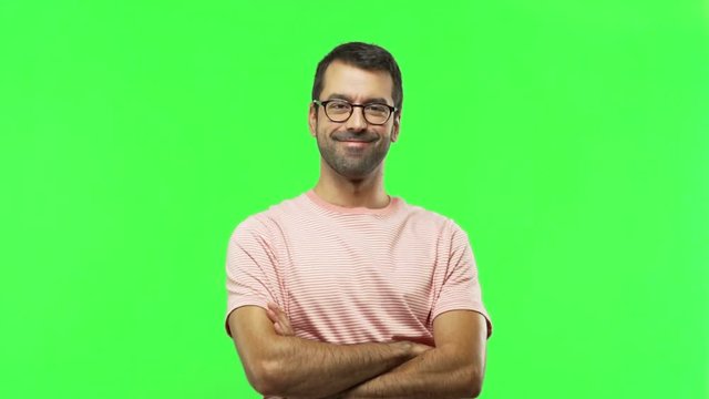 man keeping the arms crossed in confident expression  on green screen chroma key background