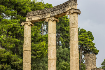 pillars colonnade antique ruins temple of ancient Greece in park garden outdoor environment, tourist tour concept  