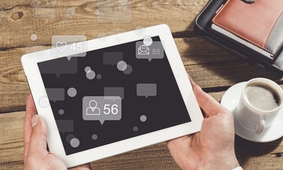 Digital tablet in hand.