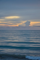 A golden scene of sunset reflection on the Haad Son beach, Khao Lak, Phang Nga, Thailand during summer time.
