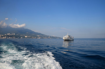 Ship in the sea on the waves. District of Yalta, Crimea, Black Sea.