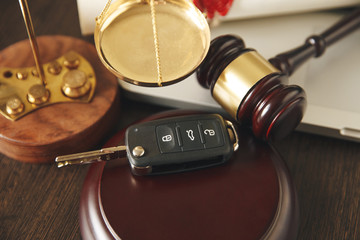 Car auction concept - gavel and car key on the wooden desk