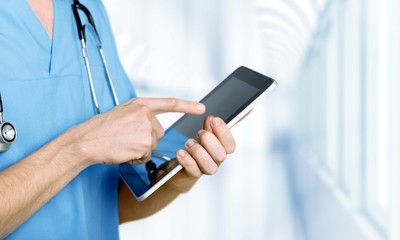 Young man doctor holding stethoscope