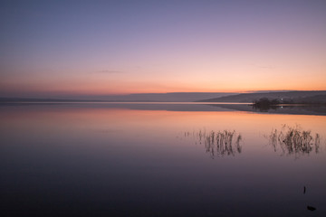 Fototapeta na wymiar morning orange sky reflection in the lake stil water