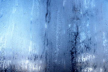 Nature background with frozen water drops on window glass