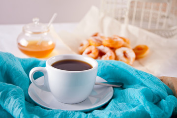 Fresh donut with cup of coffee on the table