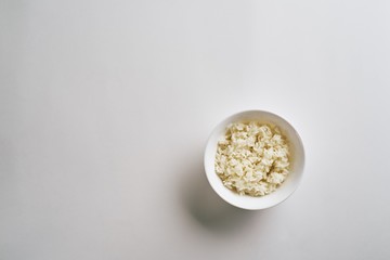 Cooked rice in plate isolated on white background. Top view