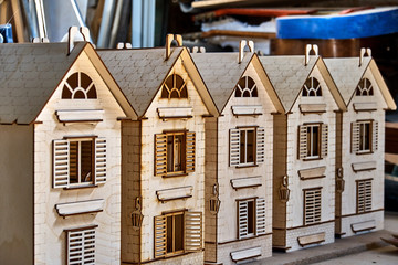 Laser cut plywood dollhouse in workshop. Plywood toys production. Close-up