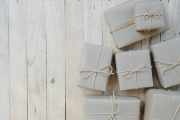 Fototapeta na wymiar Eco friendly gift boxes wrapped with brown paper, green happy new year present concept