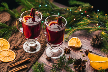 Two glasses of Christmas mulled wine with spices and orange slices. A traditional drink for the...