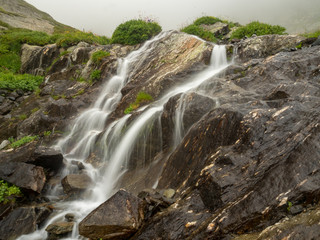 cascade waterfall on brown stones