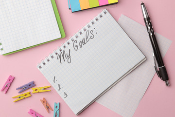 My goals 2019. The text in a notebook with colored stickers and a pen on a bright pink background.