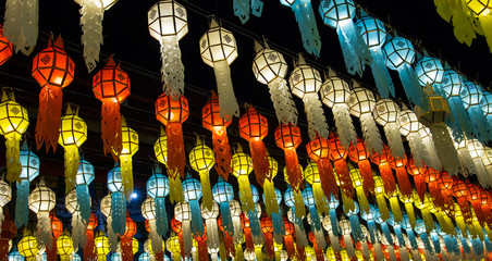 colorful hanging lanterns lighting on night sky in loy krathong festival at northern of thailand