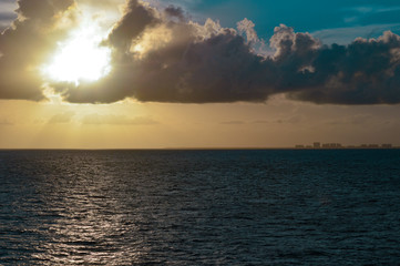 Sunset beginning to set with salmon hues and dark clouds